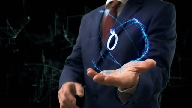 Businessman shows concept hologram 3d ring on his hand. Man in business suit with future technology screen and modern cosmic background