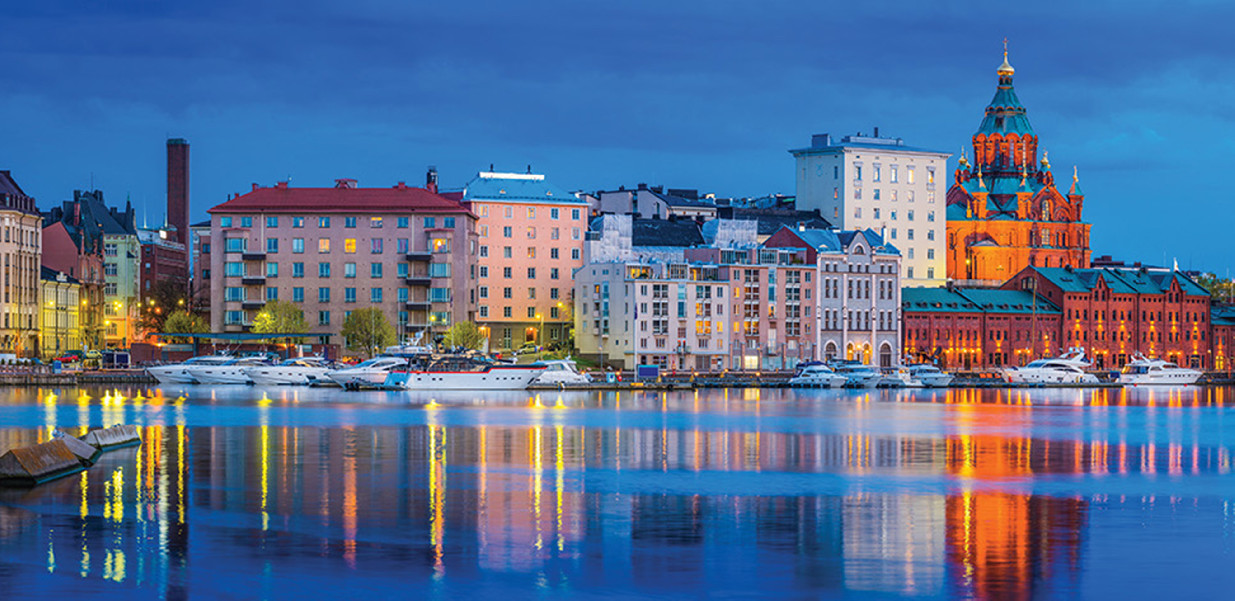 The iconic domes of Uspenski Cathedral overlooking the redeveloped warehouses, restaurants and waterfront apartments of Katajanokka and the boats moored in the tranquil blue waters of the north habour in the heart of Helsinki, Finland's vibrant capital city. ProPhoto RGB profile for maximum color fidelity and gamut.